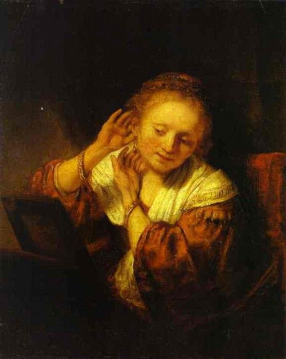 Rembrandt - A Young Woman Trying on Earings.    